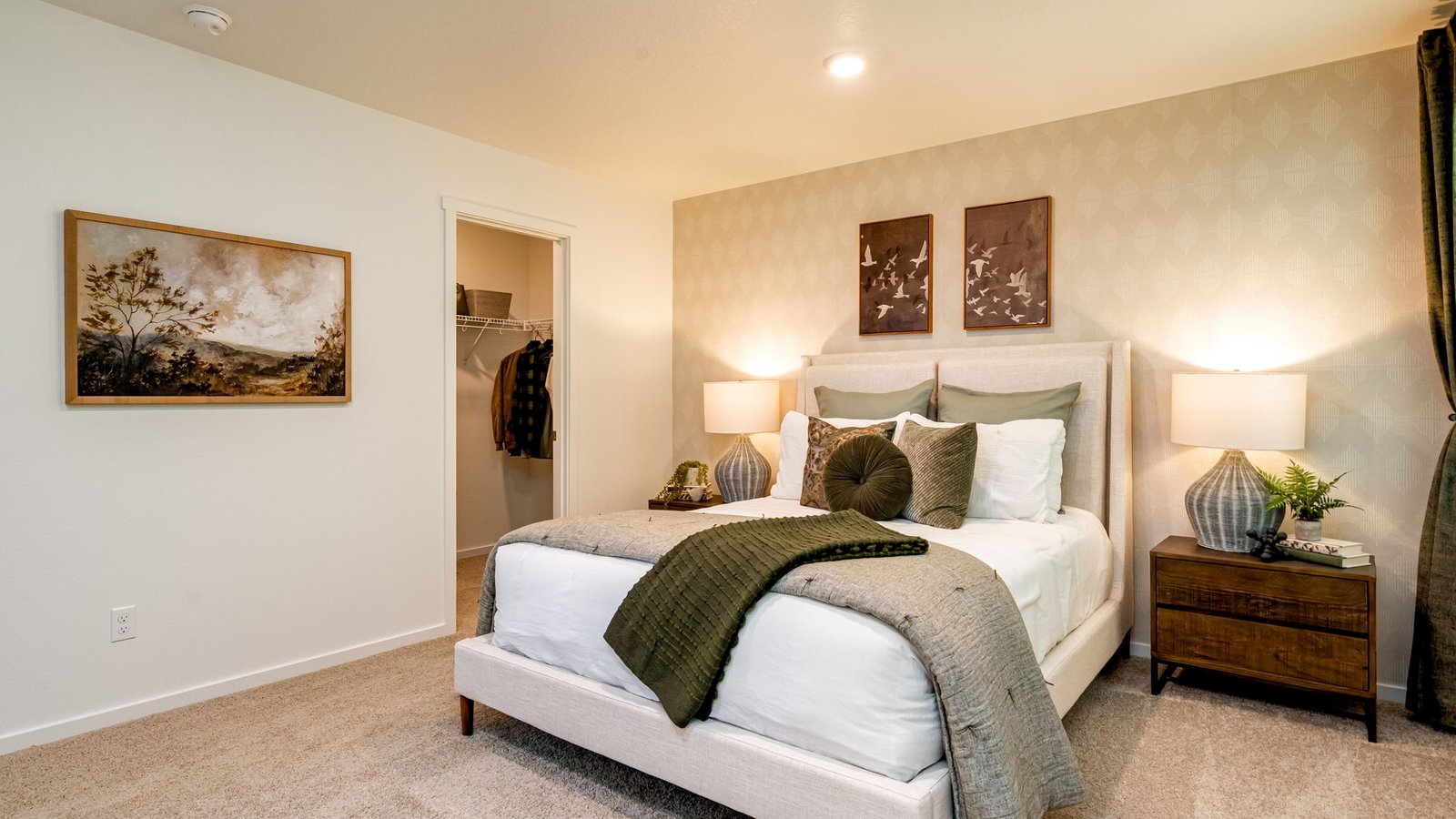 Primary bedroom with wall-to-wall carpet, a walk-in closet and an attached bathroom