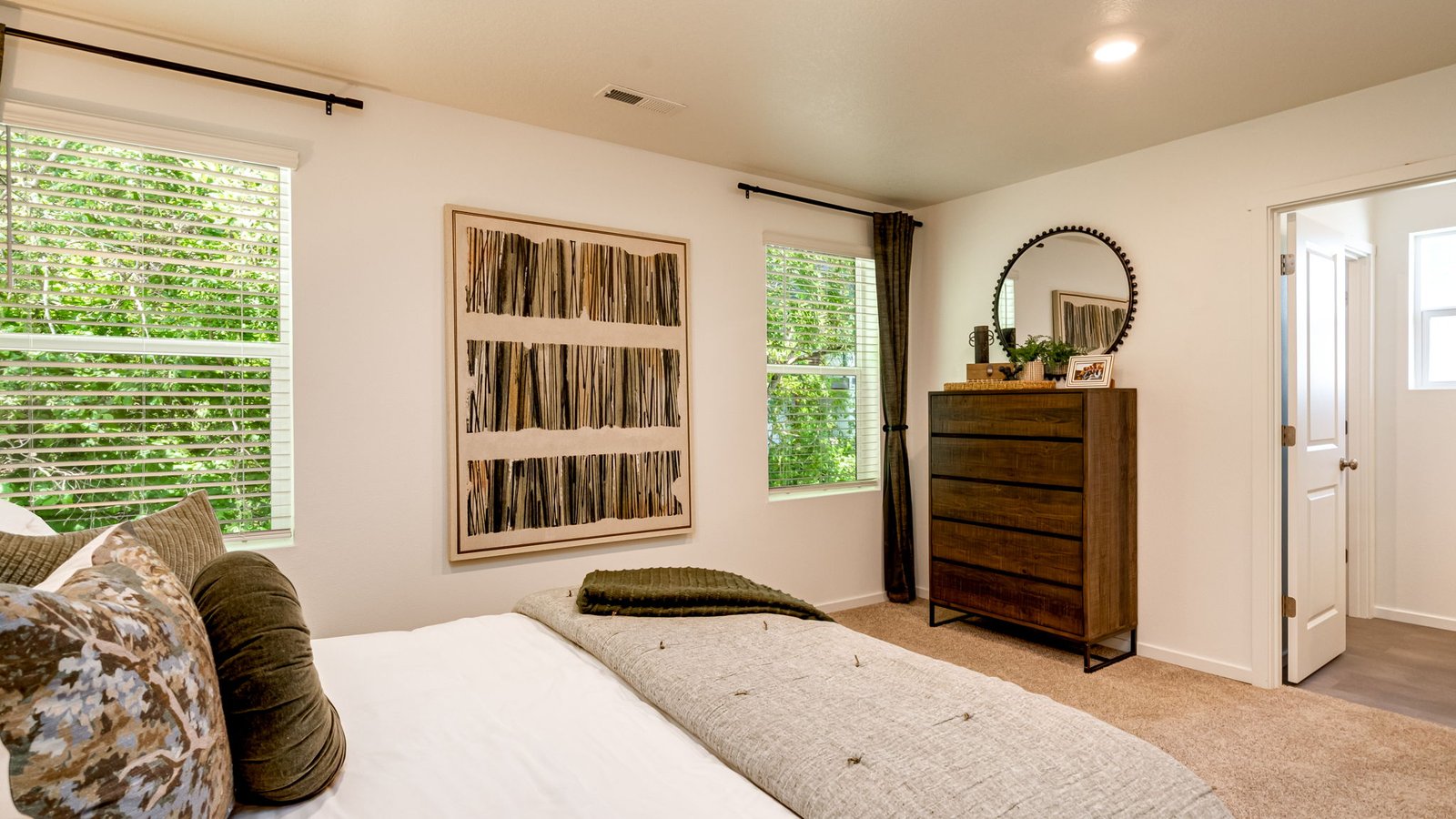 Primary bedroom with wall-to-wall carpet, a walk-in closet and an attached bathroom