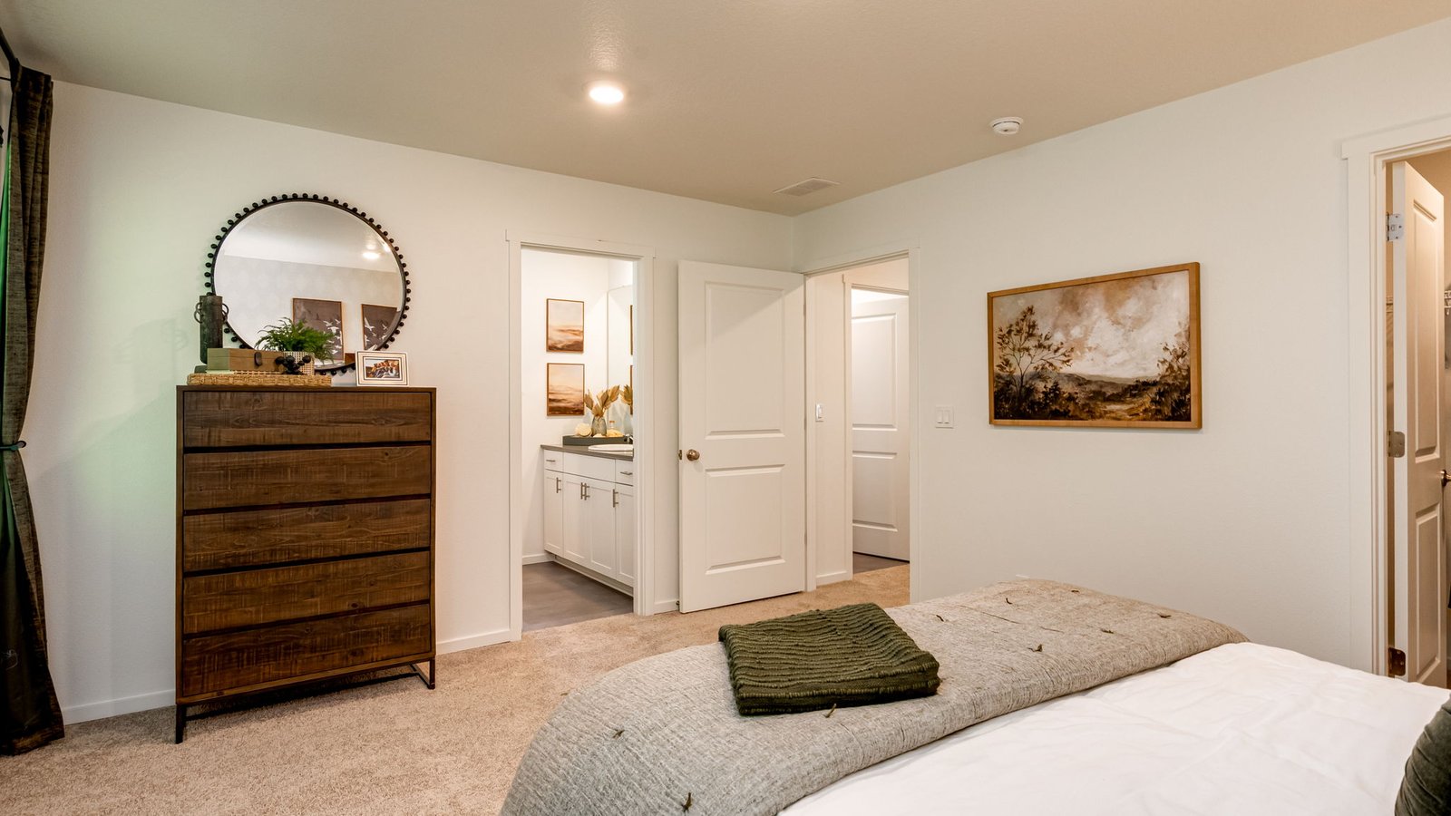 Primary bedroom with wall-to-wall carpet, a walk-in closet and an attached bathroom