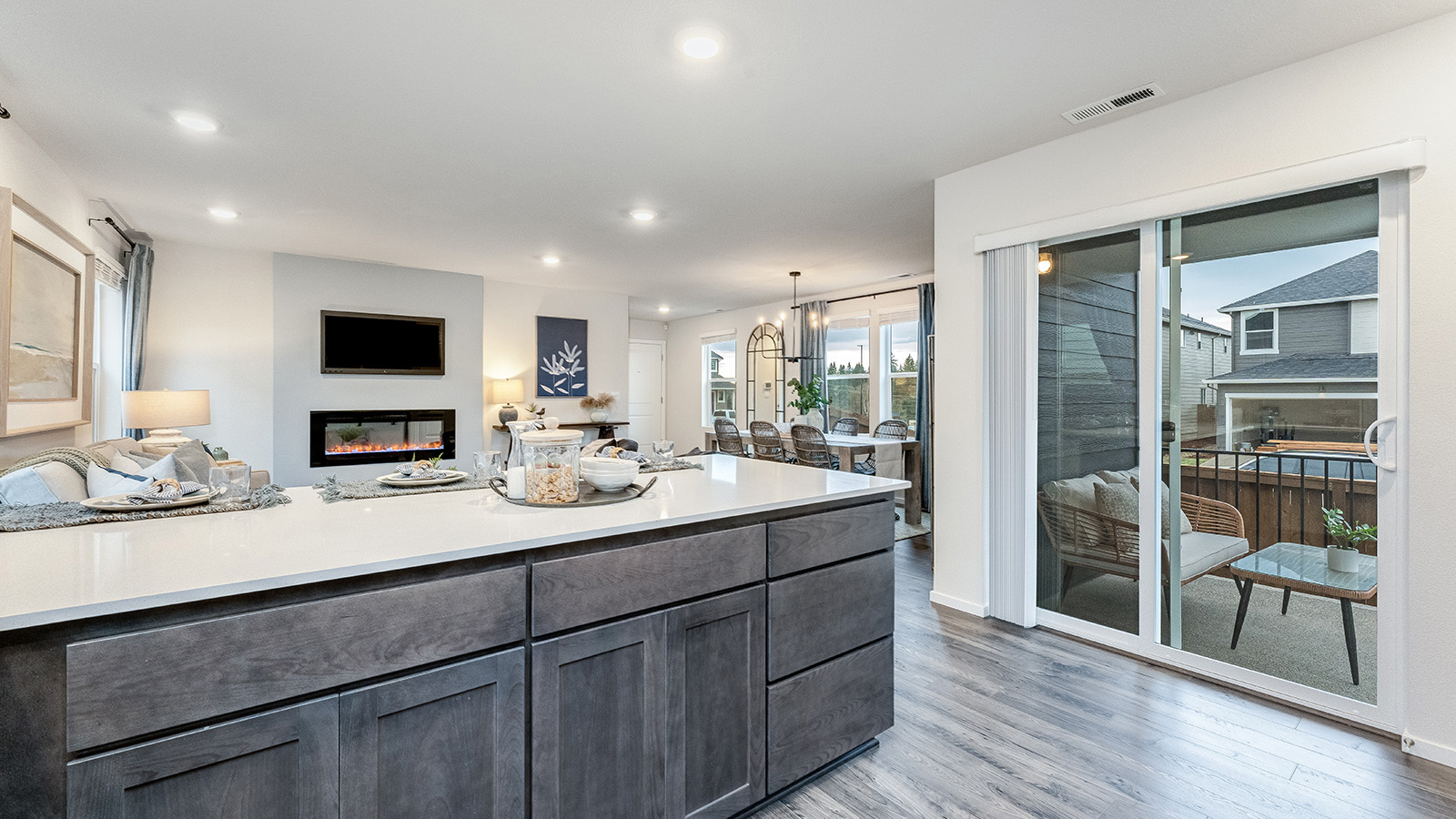 U-shaped kitchen with shaker cabinets, quartz counters, stainless steel appliances, pantry, and a breakfast bar