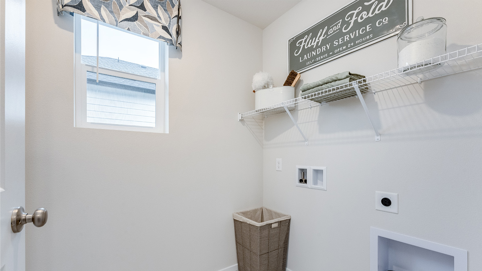 Laundry room with wire shelves and washer and dryer hookups