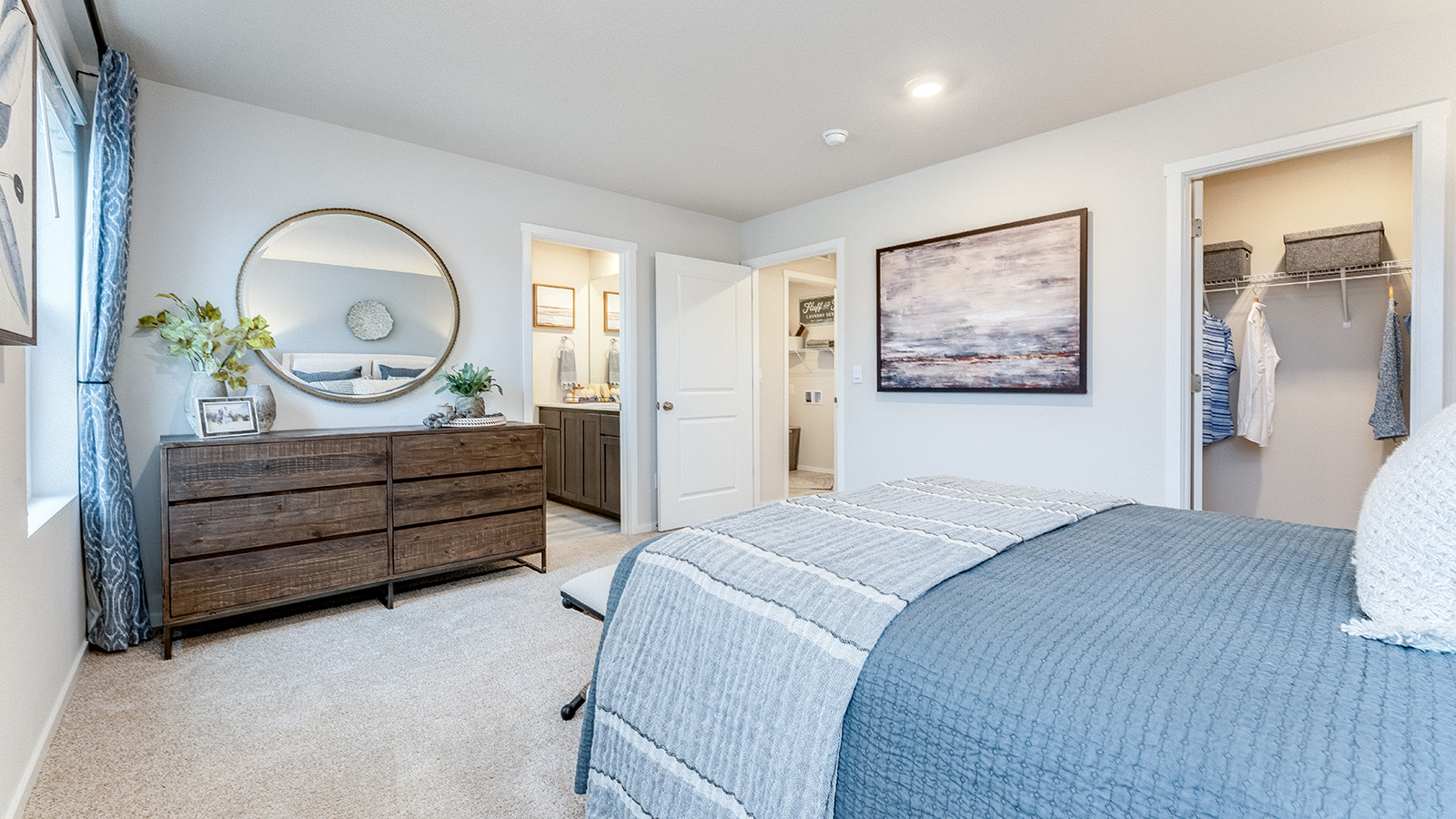 Primary bedroom with wall-to-wall carpet, a walk-in closet and an attached bathroom