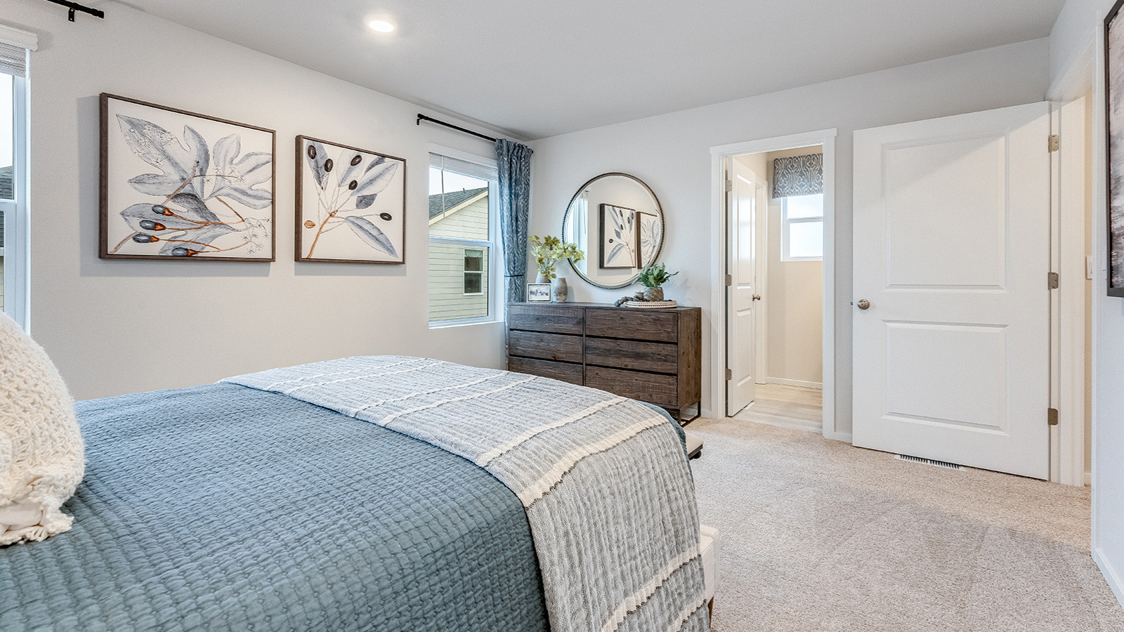Primary bedroom with wall-to-wall carpet, a walk-in closet and an attached bathroom