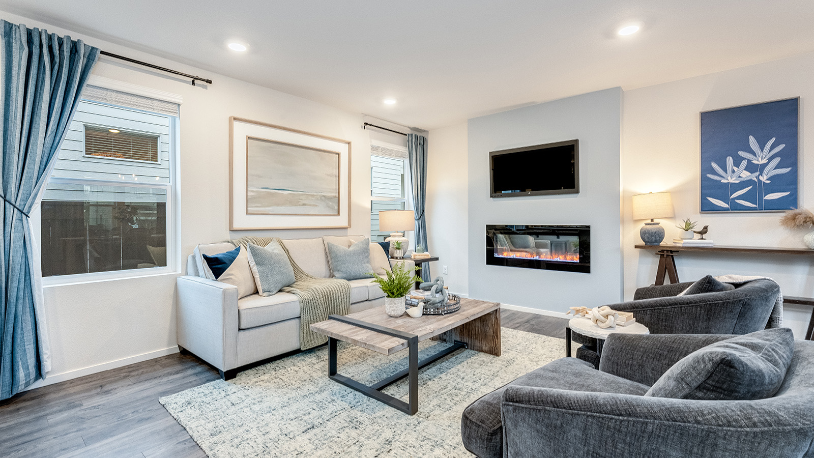 Great room with laminate flooring and an electric fireplace