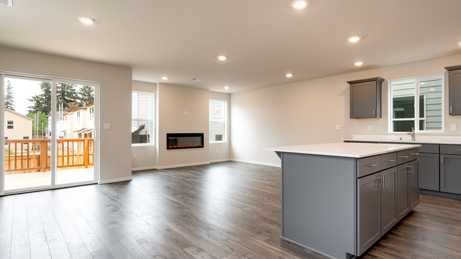 Kitchen with shaker cabinets, quartz counters, stainless steel appliances, pantry, and an island with a breakfast bar