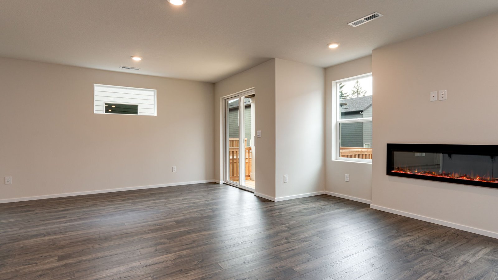 Great room with laminate flooring and an electric fireplace