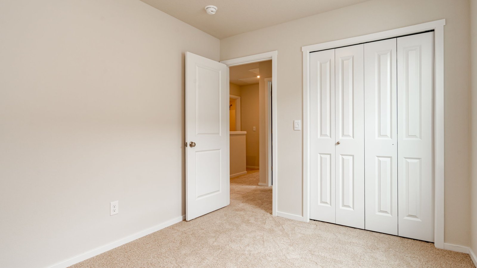 Bedroom with wall-to-wall carpet and a closet