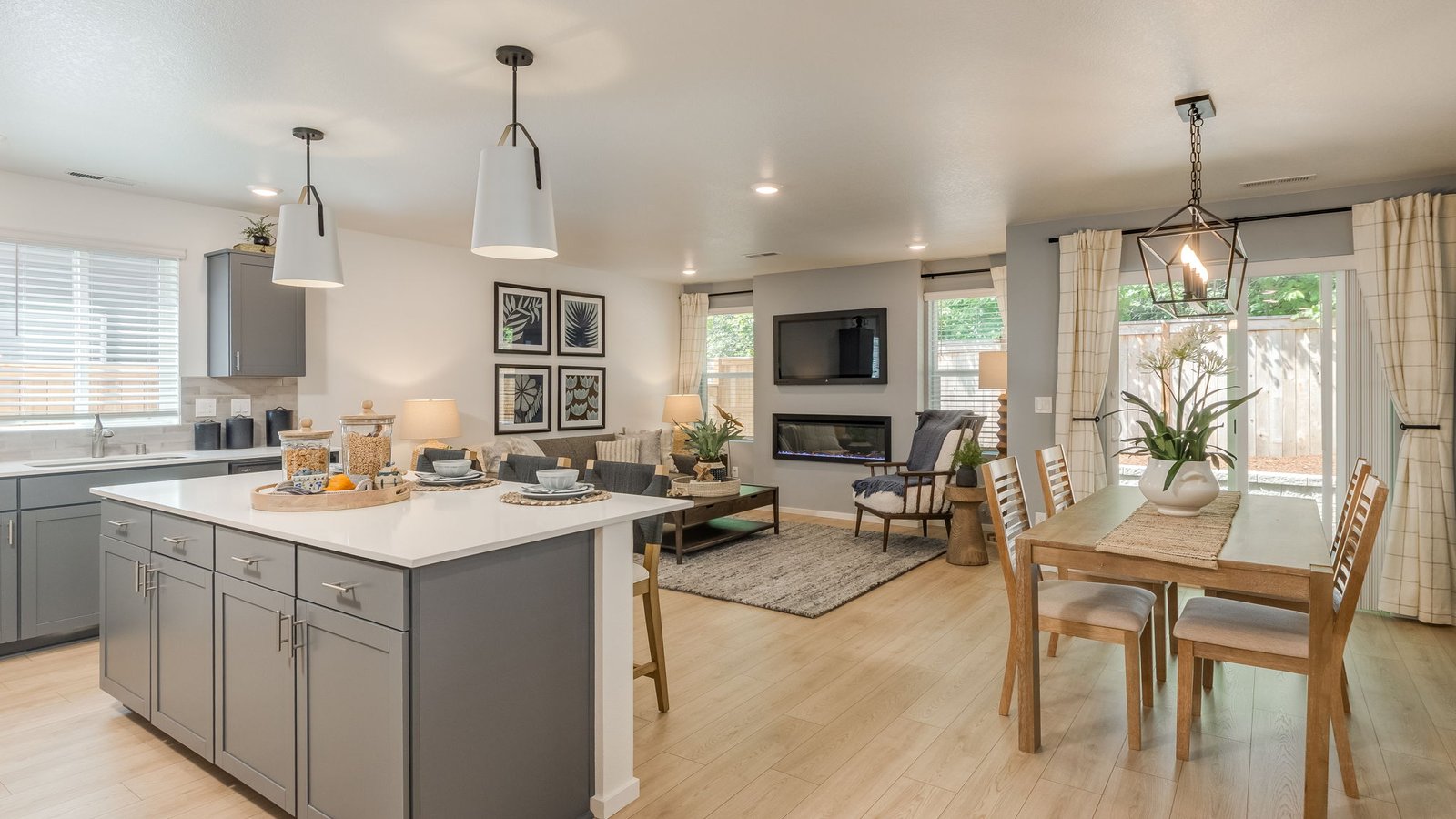 Kitchen with shaker cabinets, quartz counters, stainless steel appliances, pantry, and an island with a breakfast bar