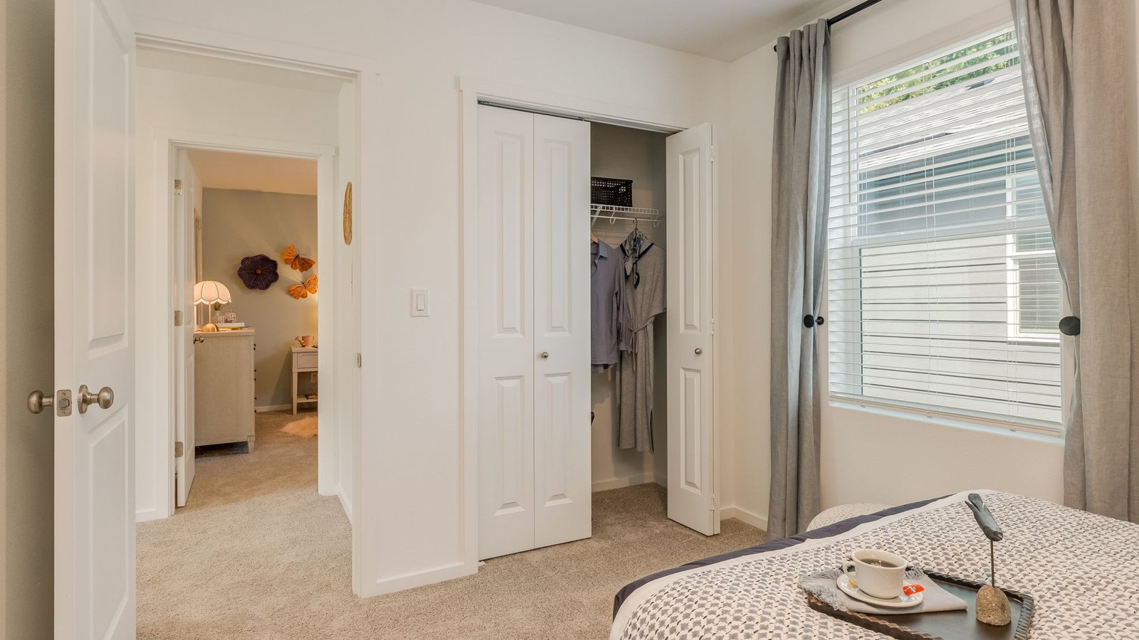 Bedroom with wall-to-wall carpet and a closet