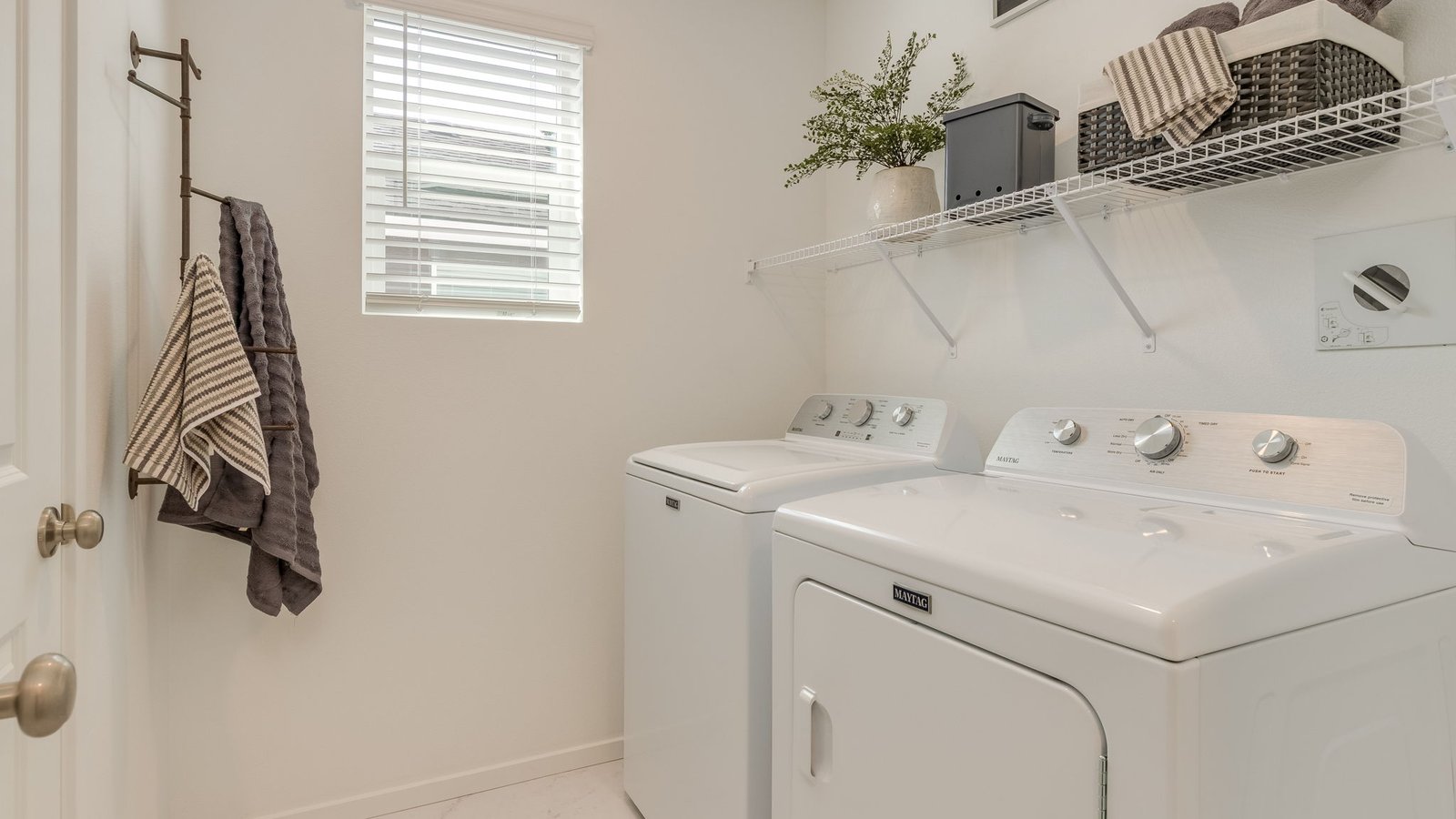 Laundry room with wire shelves and washer and dryer hookups