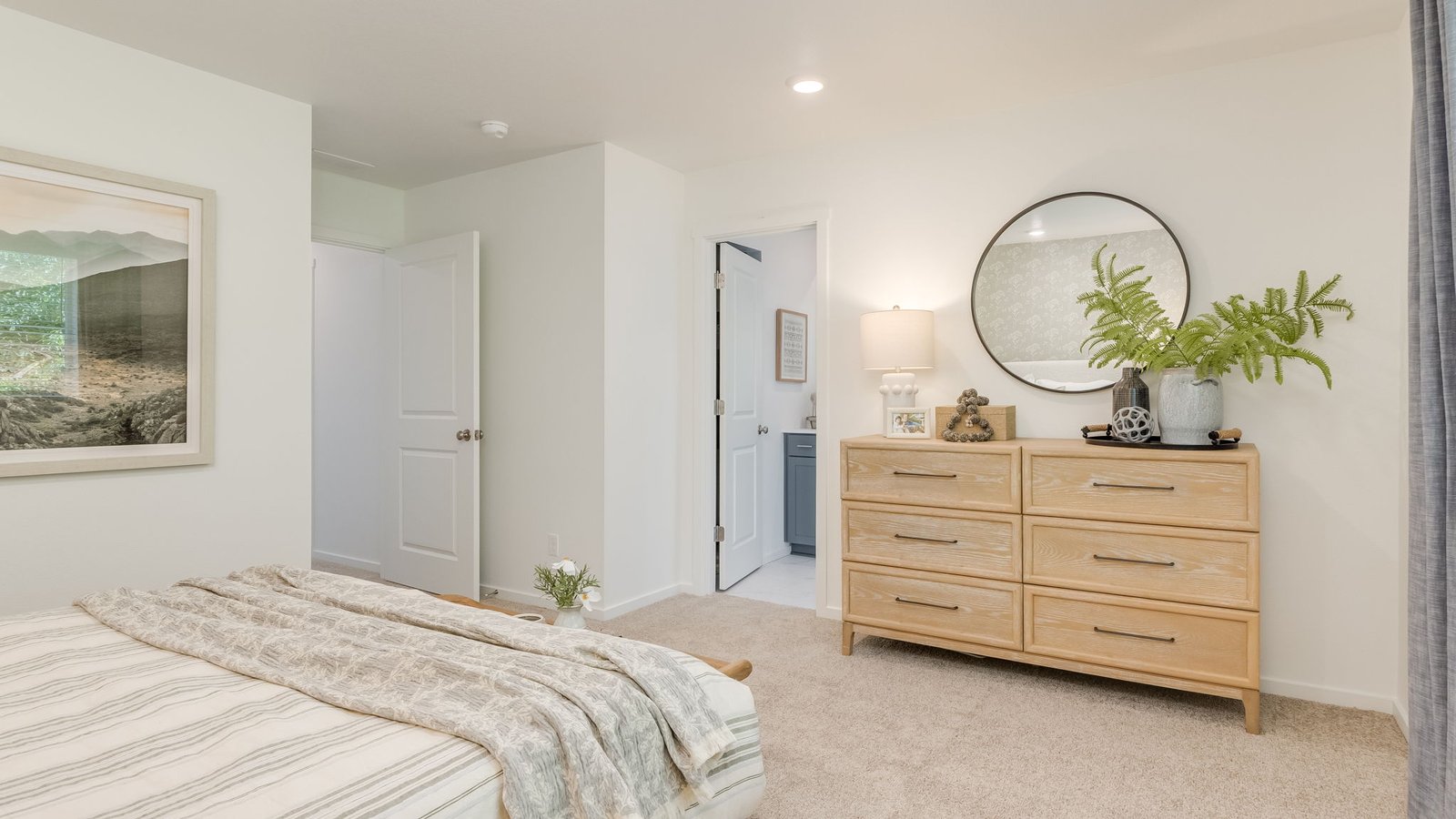 Primary bedroom with wall-to-wall carpet, a walk-in closet and an attached bathroom