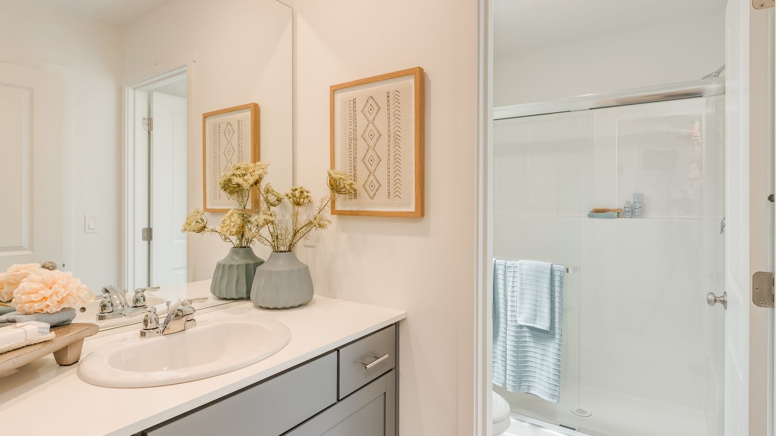 Primary bathroom with quartz counters and a walk-in shower