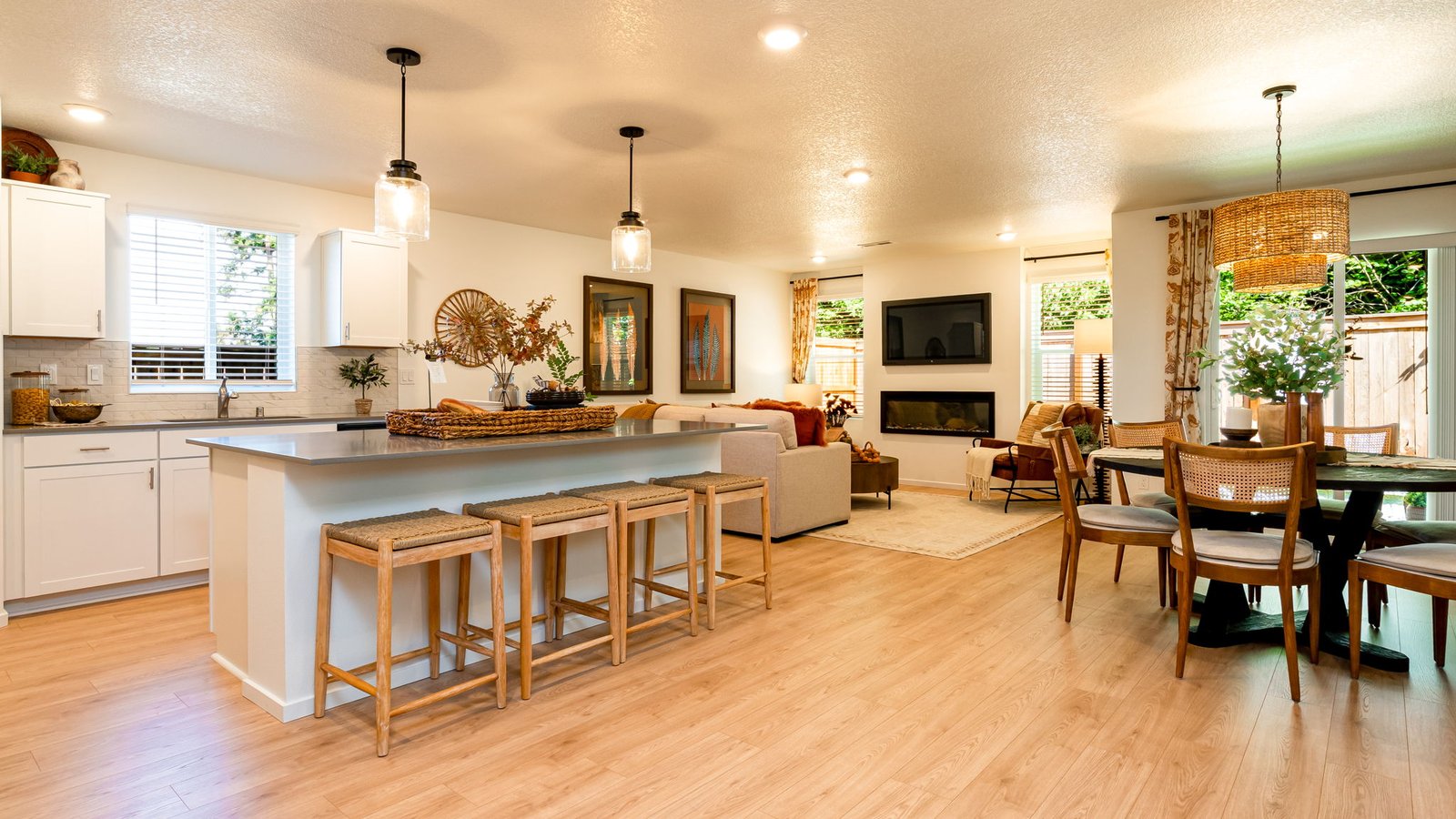 Kitchen with shaker cabinets, quartz counters, stainless steel appliances, pantry, and an island with a breakfast bar