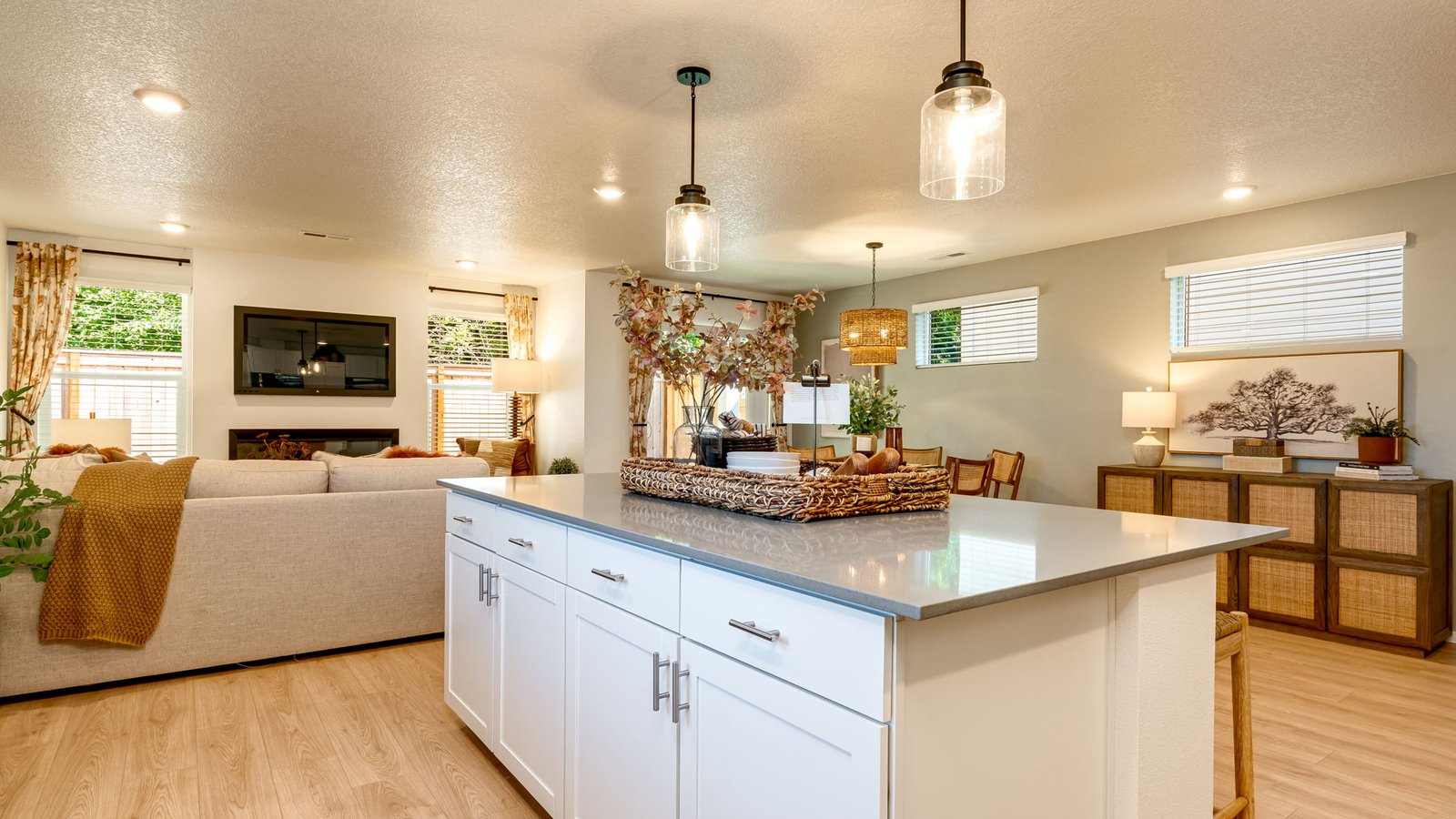 Kitchen with shaker cabinets, quartz counters, stainless steel appliances, pantry, and an island with a breakfast bar