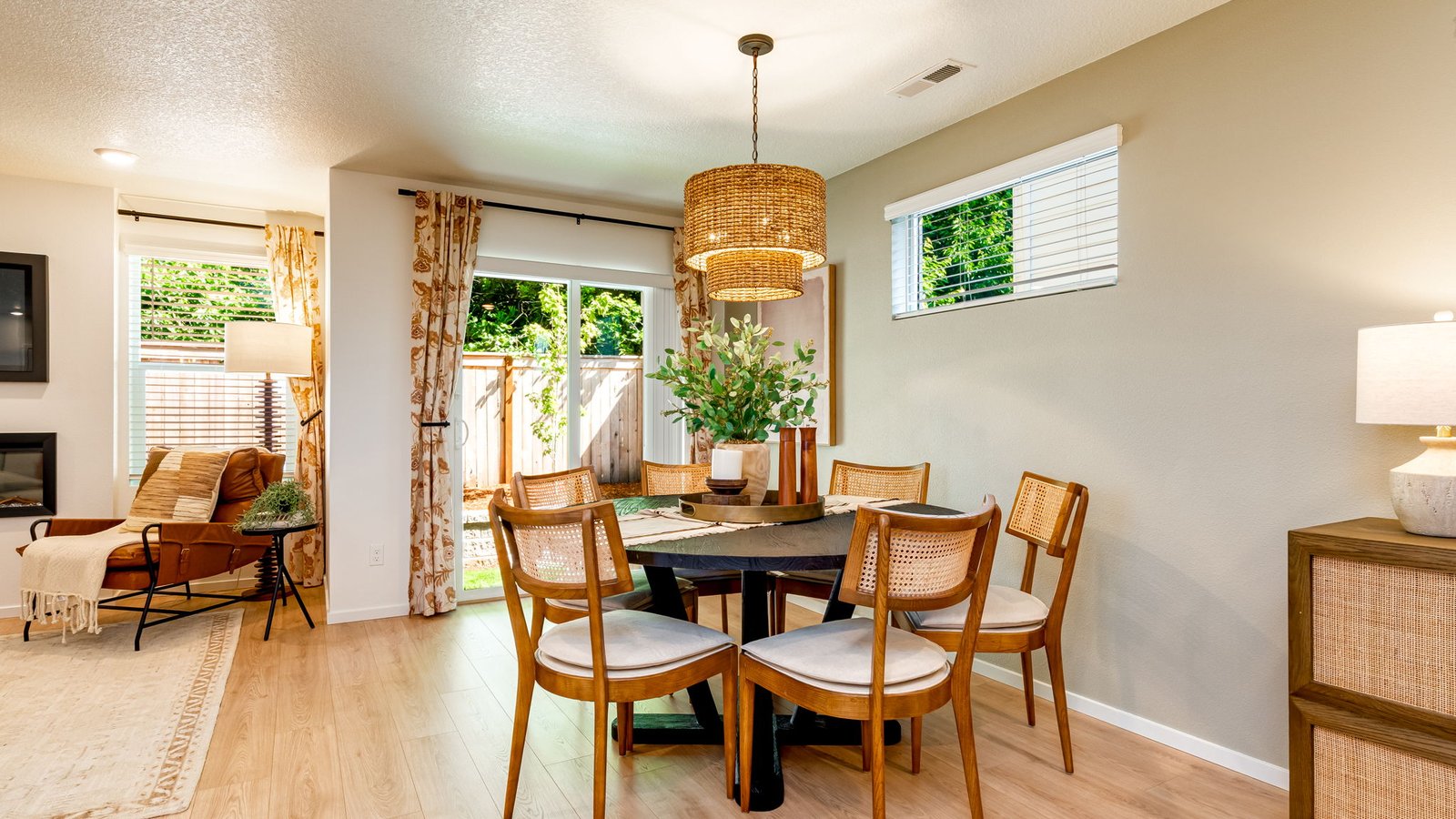Dining area with a sliding glass door to a fenced backyard