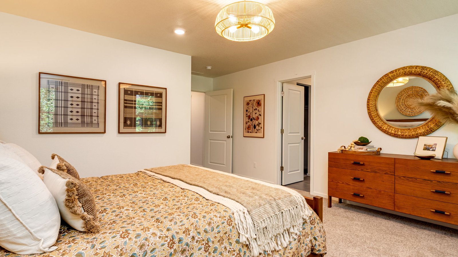 Primary bedroom with wall-to-wall carpet, a walk-in closet and an attached bathroom
