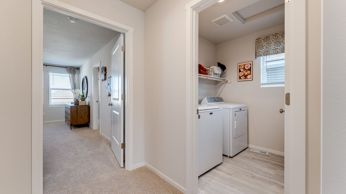 Laundry room with built-in shelves and washer and dryer hookups