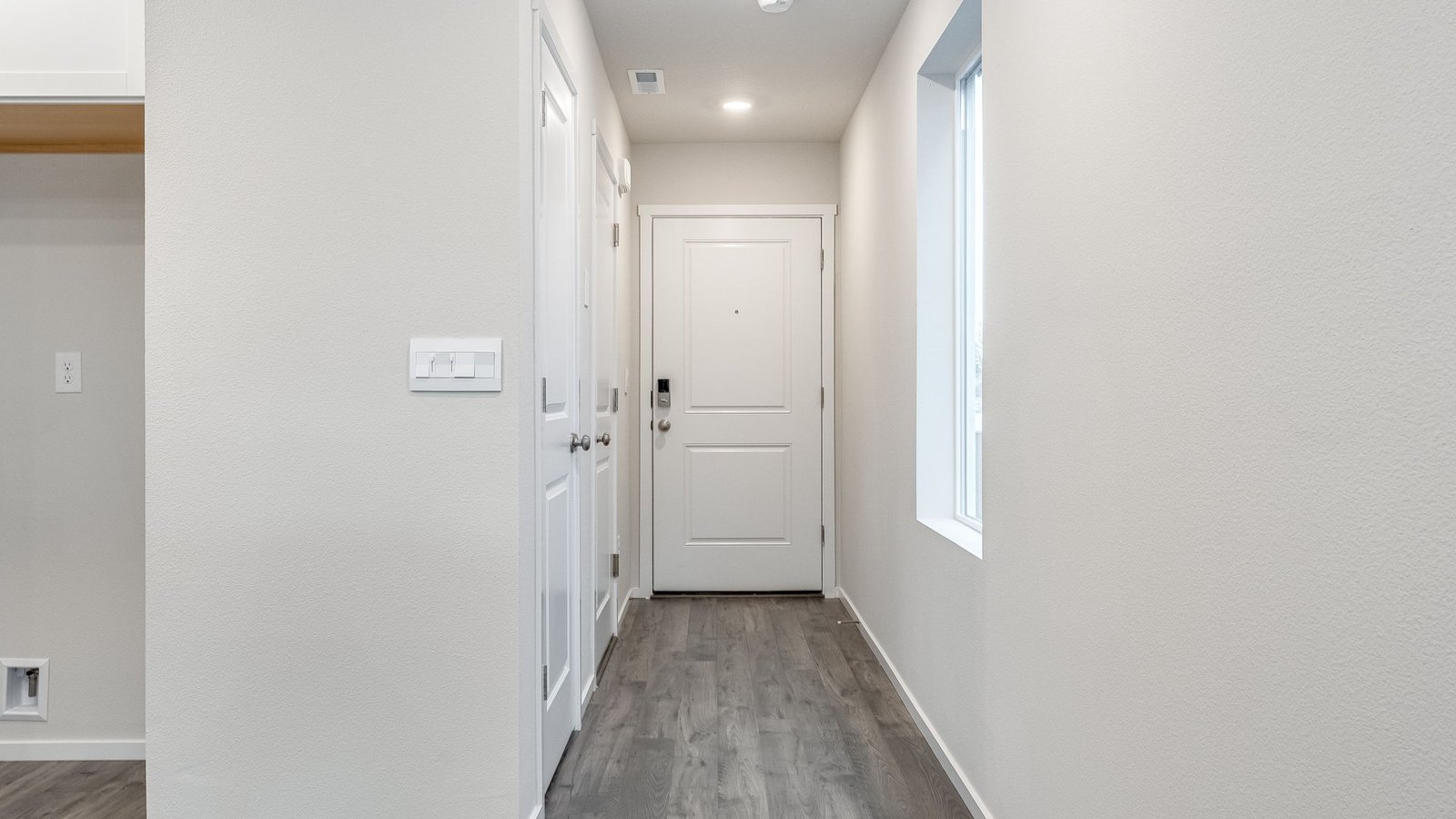 Entryway with a coat closet and laminate flooring