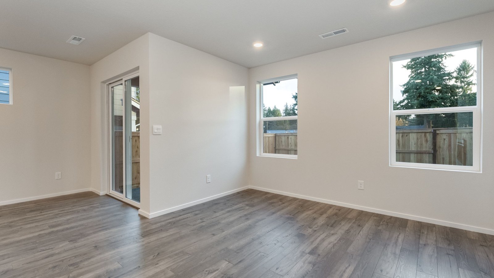 Dining area with a sliding glass door to a fenced backyard