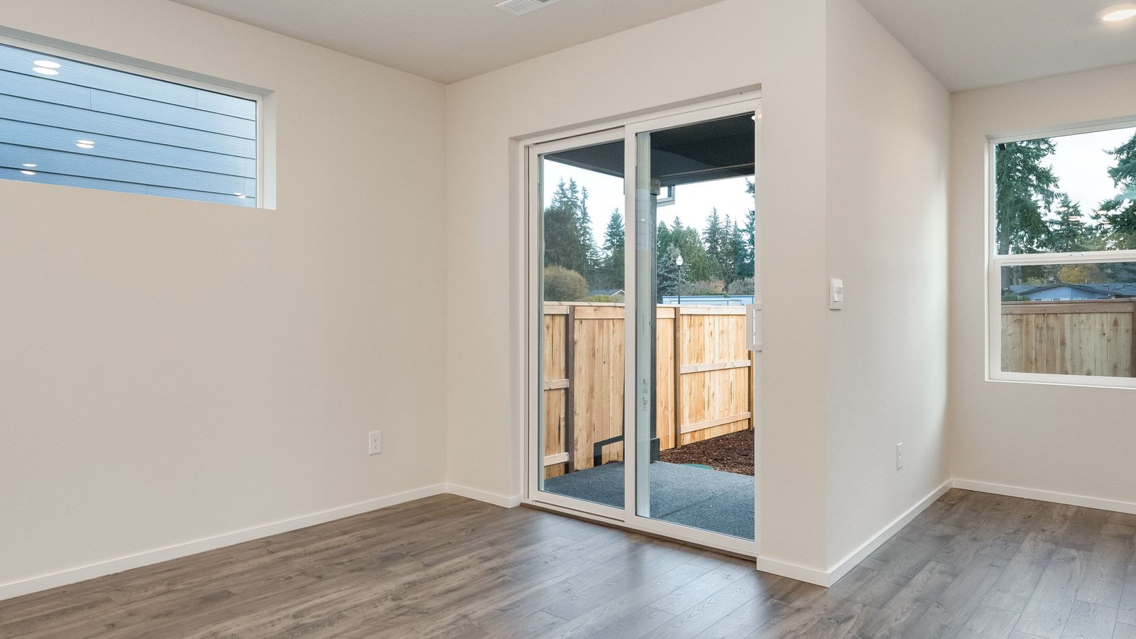 Dining area with a sliding glass door to a fenced backyard