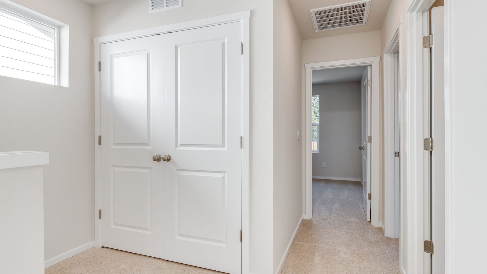 Laundry closet with wire shelves and washer and dryer hookups