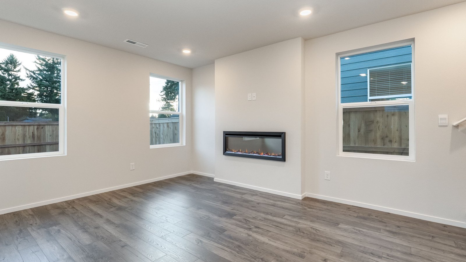 Great room with laminate flooring and an electric fireplace