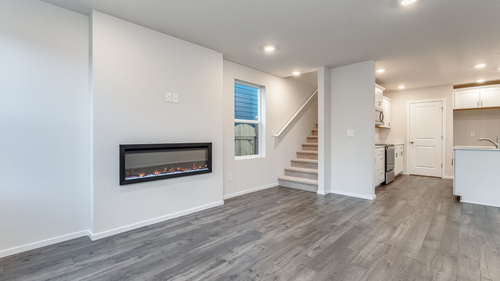 Great room with laminate flooring and an electric fireplace