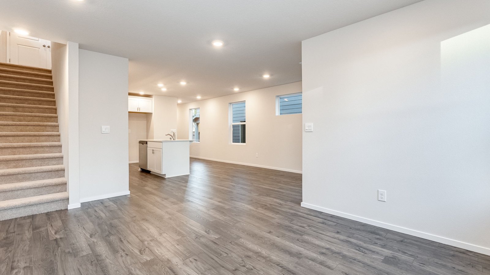 Great room with laminate flooring and an electric fireplace