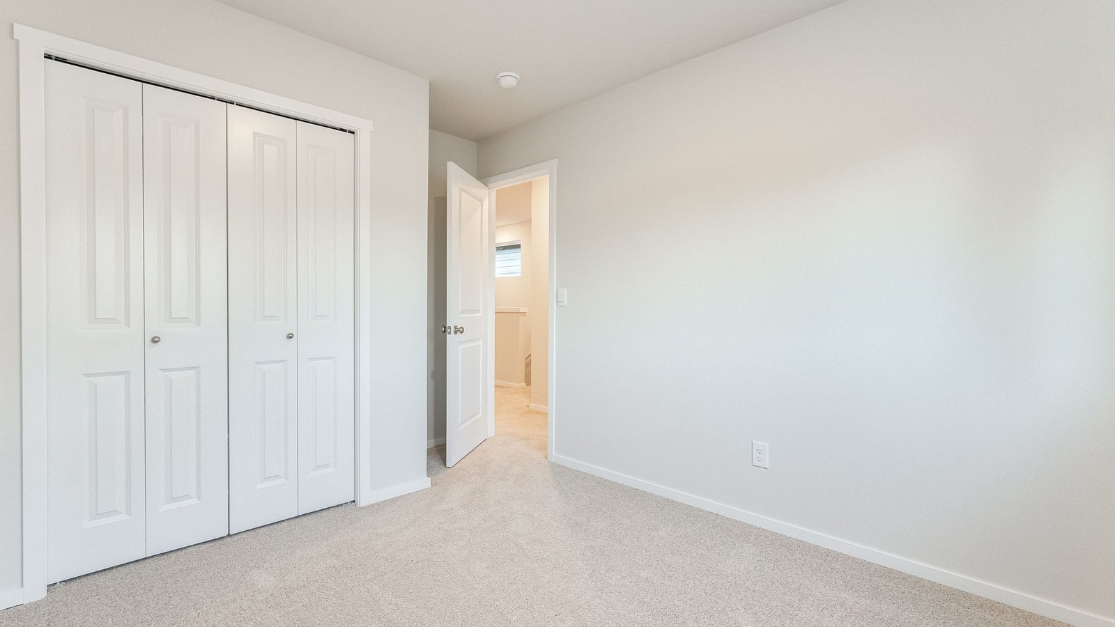 Bedroom with wall-to-wall carpet and a closet