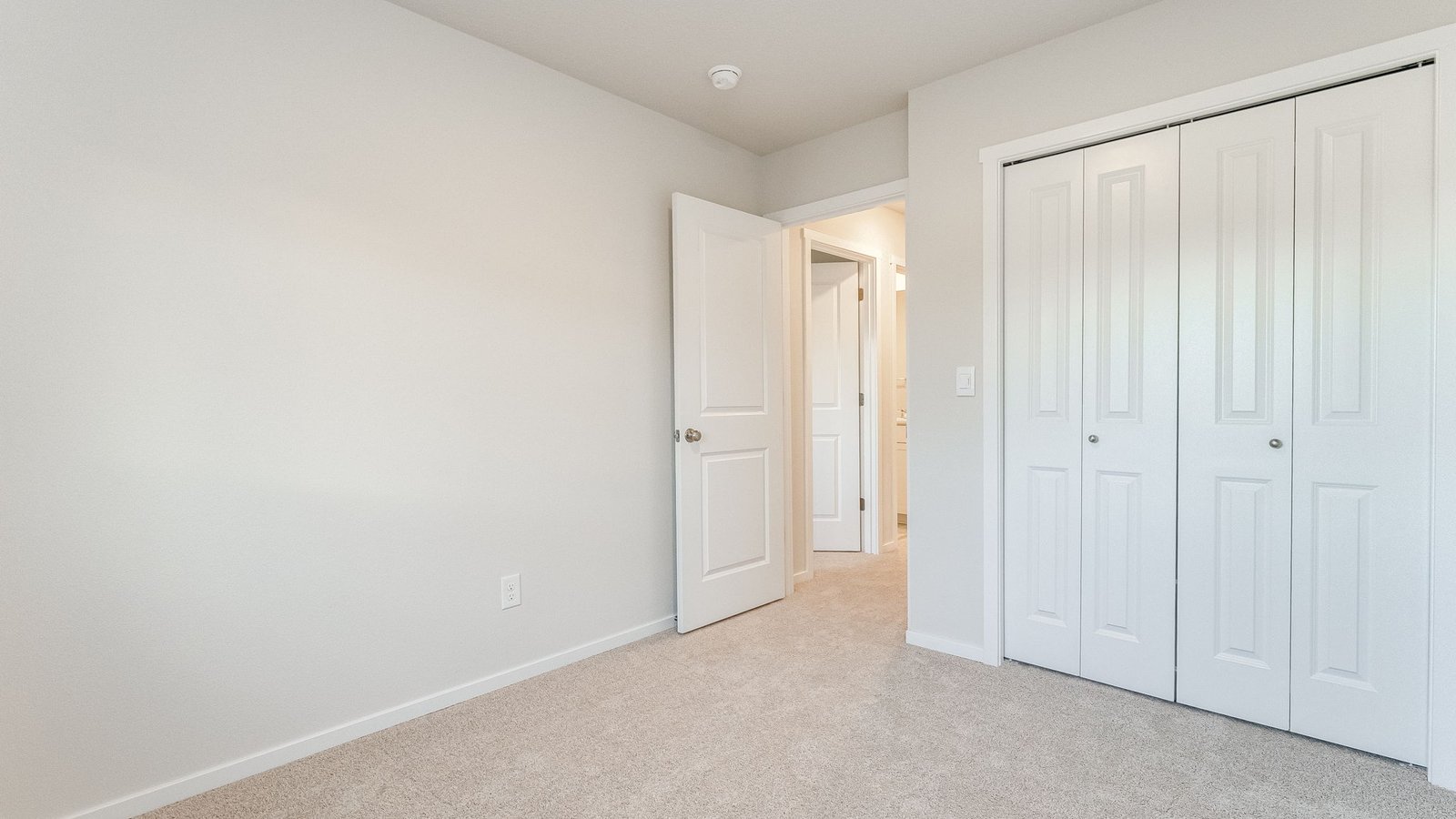 Bedroom with wall-to-wall carpet and a closet