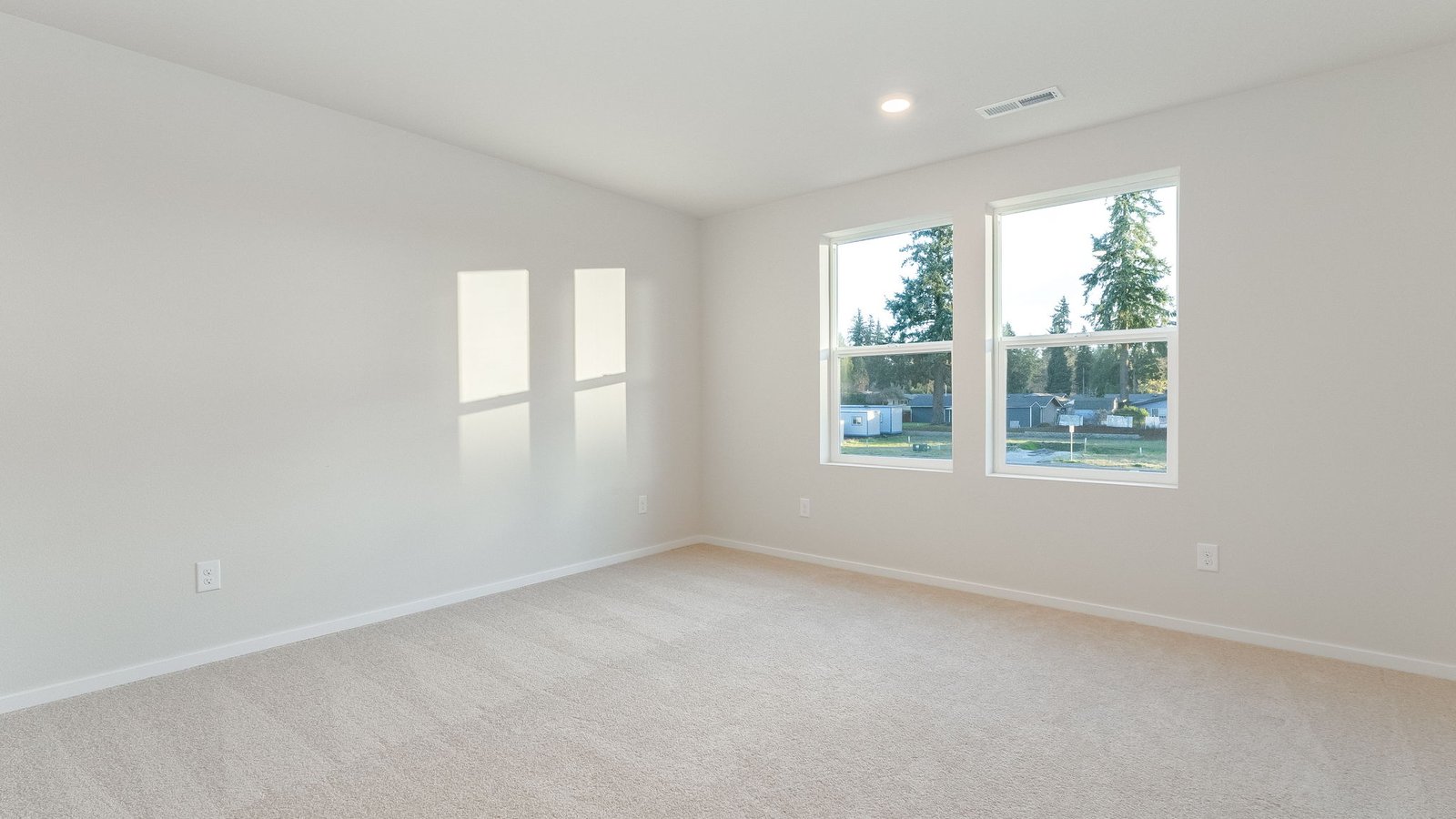 Primary bedroom with wall-to-wall carpet, a walk-in closet and an attached bathroom