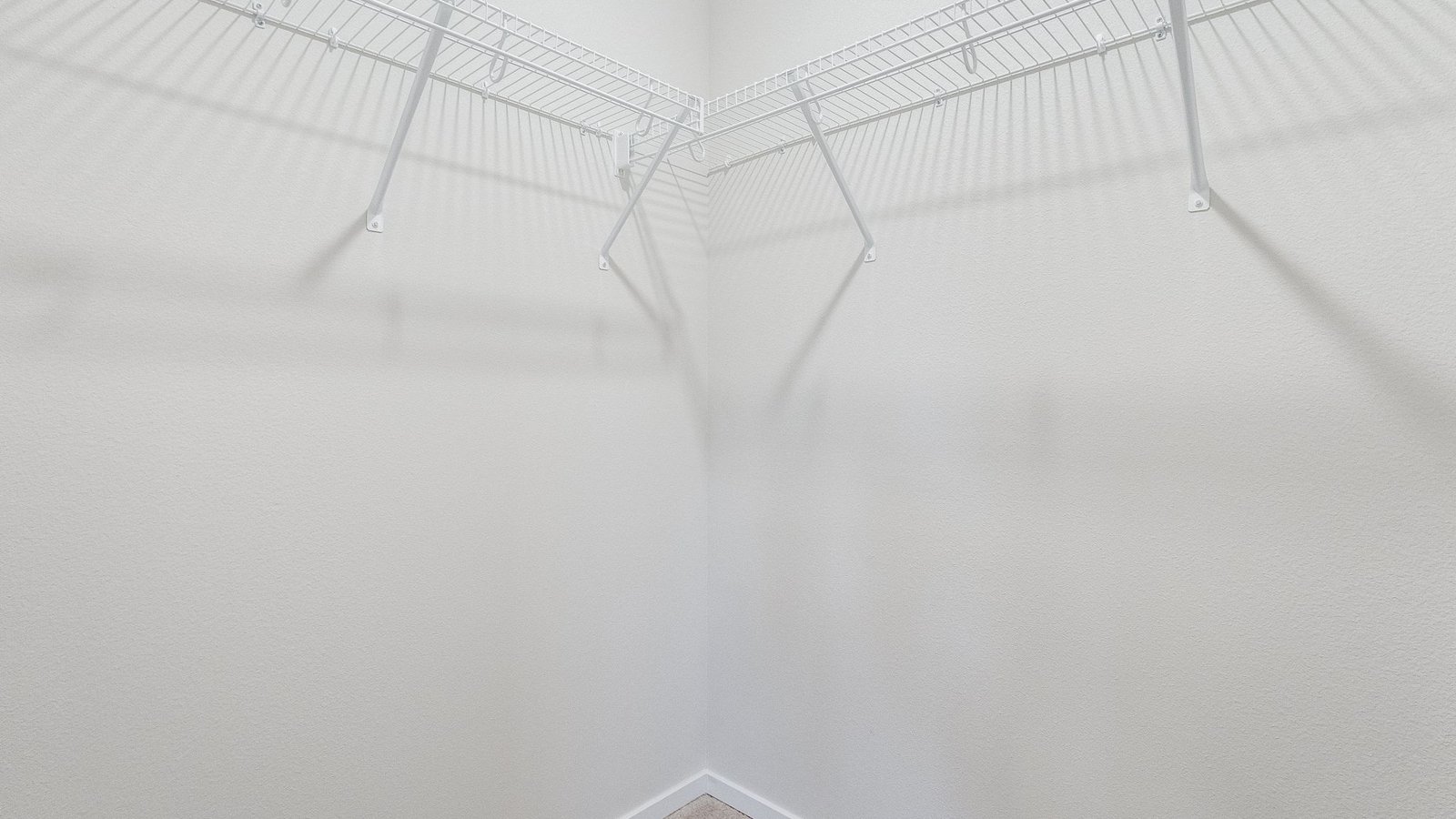 Primary bedroom walk-in closet with wire shelves