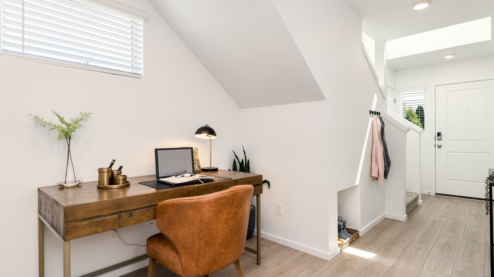 Entryway with a coat closet and laminate flooring