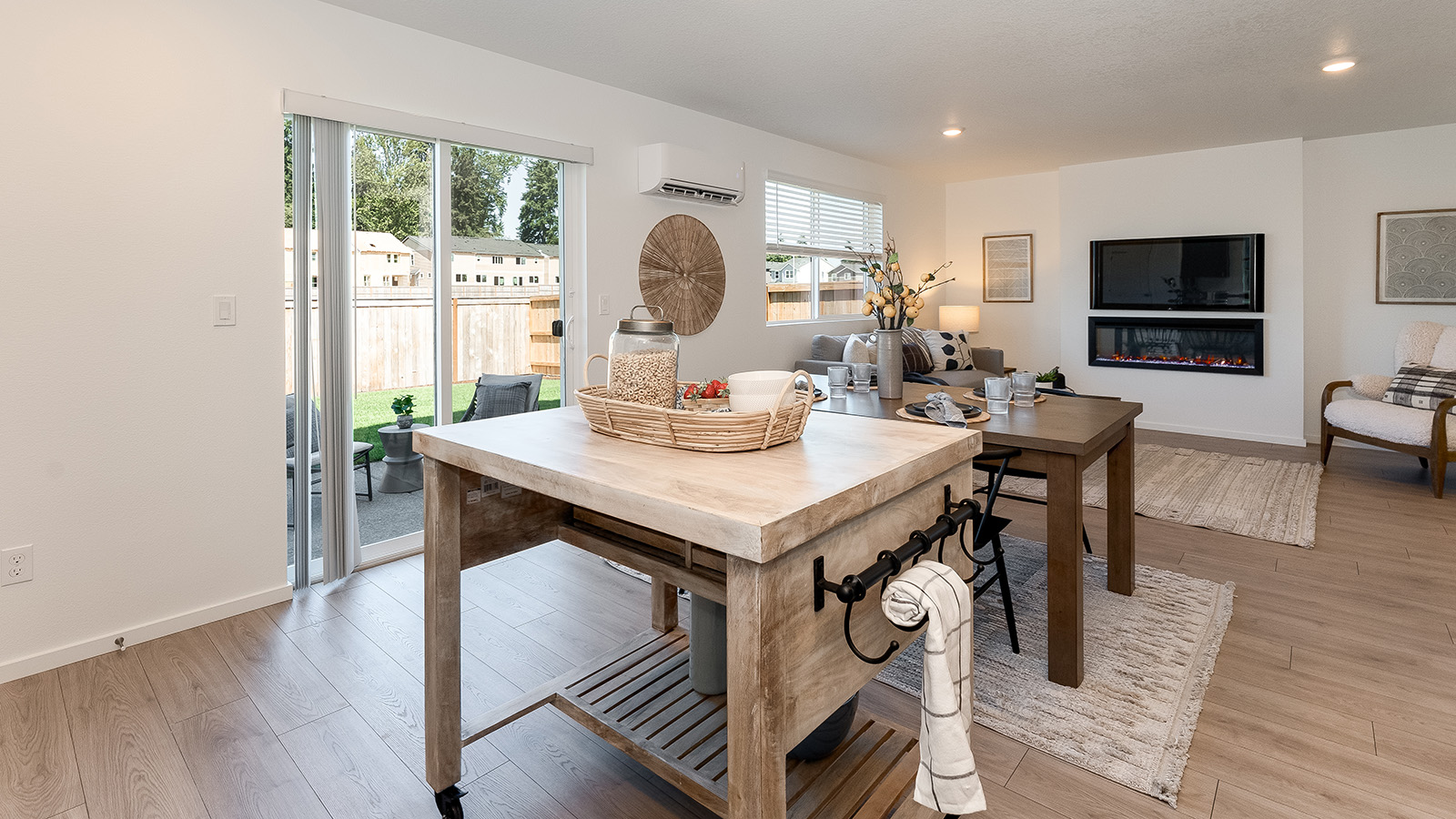 L-shaped kitchen with shaker cabinets, quartz counters, stainless steel appliances, and a pantry