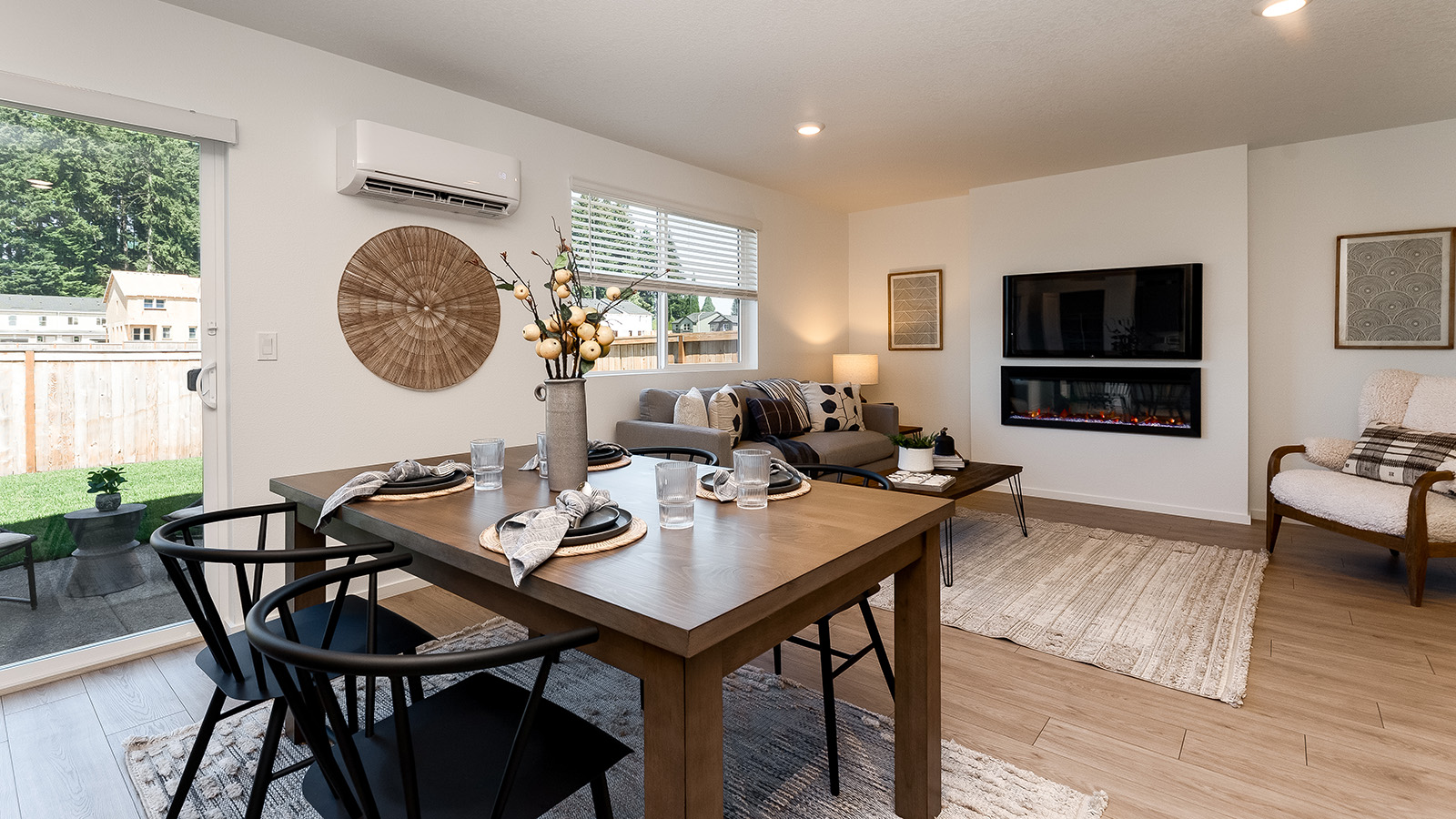 L-shaped kitchen with shaker cabinets, quartz counters, stainless steel appliances, and a pantry