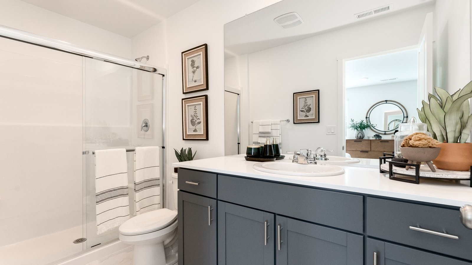 Primary bathroom with quartz counters and a walk-in shower