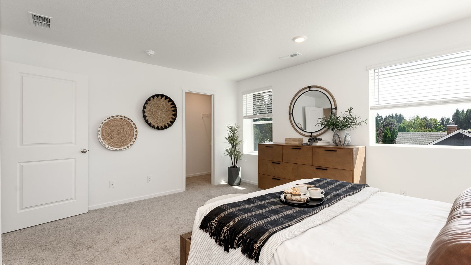Primary bedroom with wall-to-wall carpet, a walk-in closet and an attached bathroom