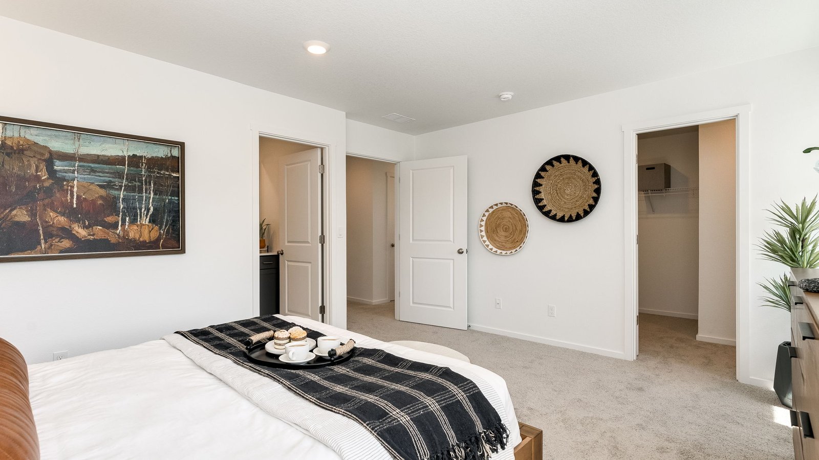 Primary bedroom with wall-to-wall carpet, a walk-in closet and an attached bathroom