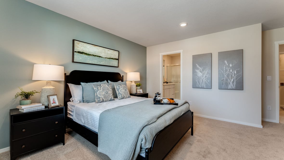 Primary bedroom with wall-to-wall carpet, a walk-in closet and an attached bathroom