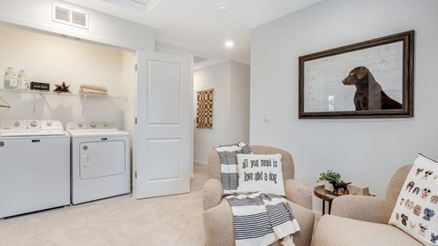 Laundry closet with wire shelves and washer and dryer hookups