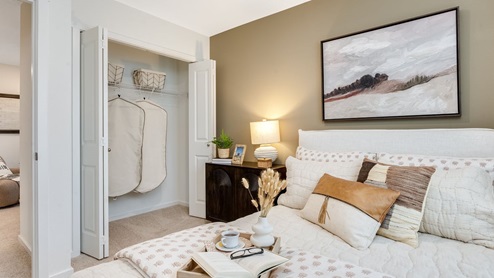 Bedroom with wall-to-wall carpet and a closet