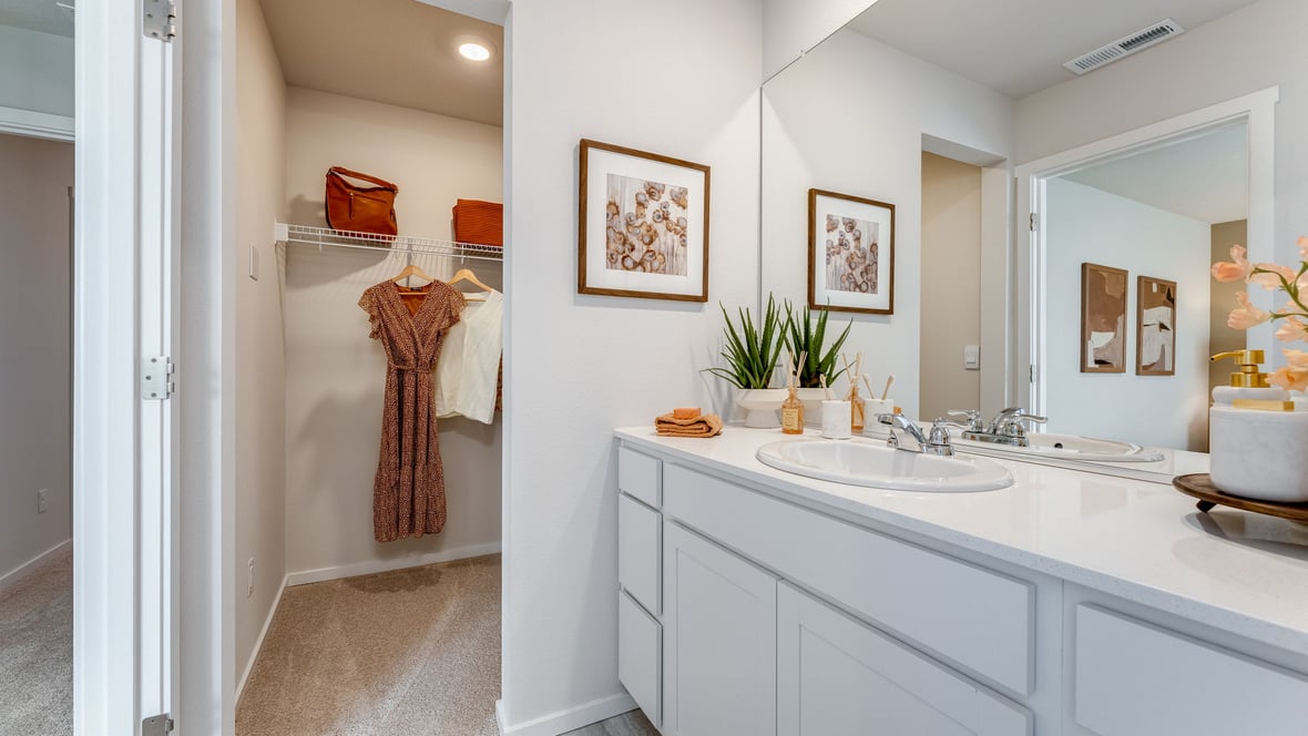 Primary bathroom with quartz counters and a walk-in shower