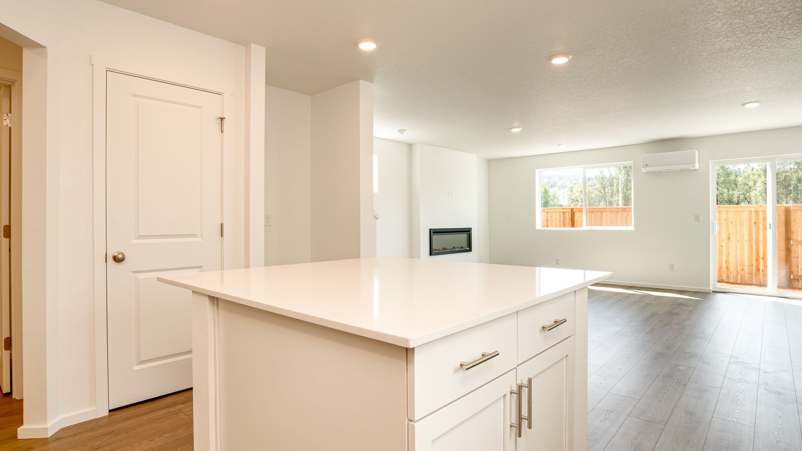 Kitchen with shaker cabinets, quartz counters, stainless steel appliances, pantry, and an island with a breakfast bar