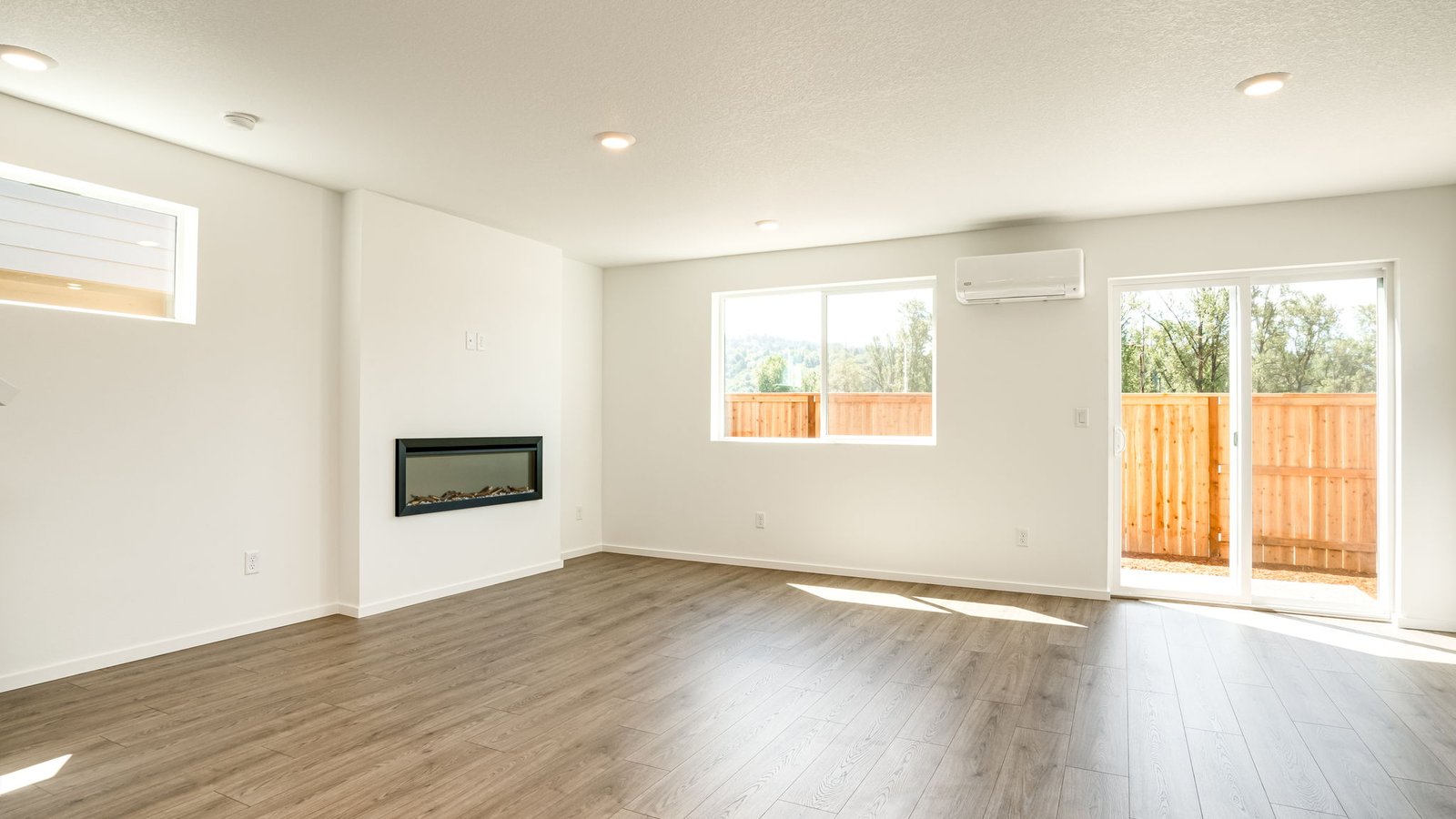 Great room with laminate flooring and an electric fireplace