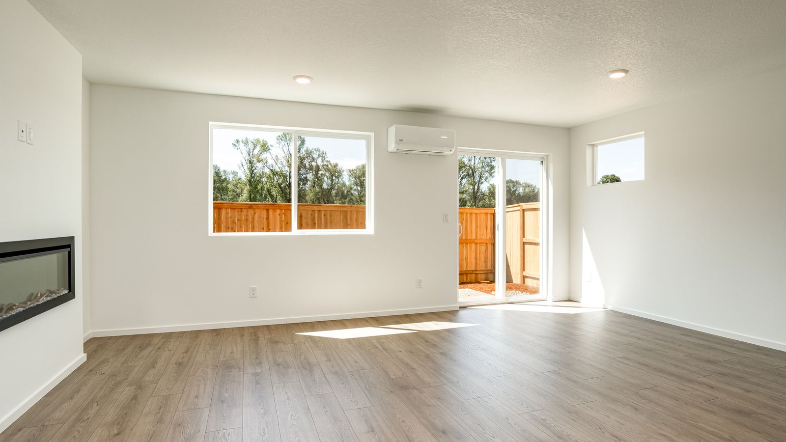 Great room with laminate flooring and an electric fireplace