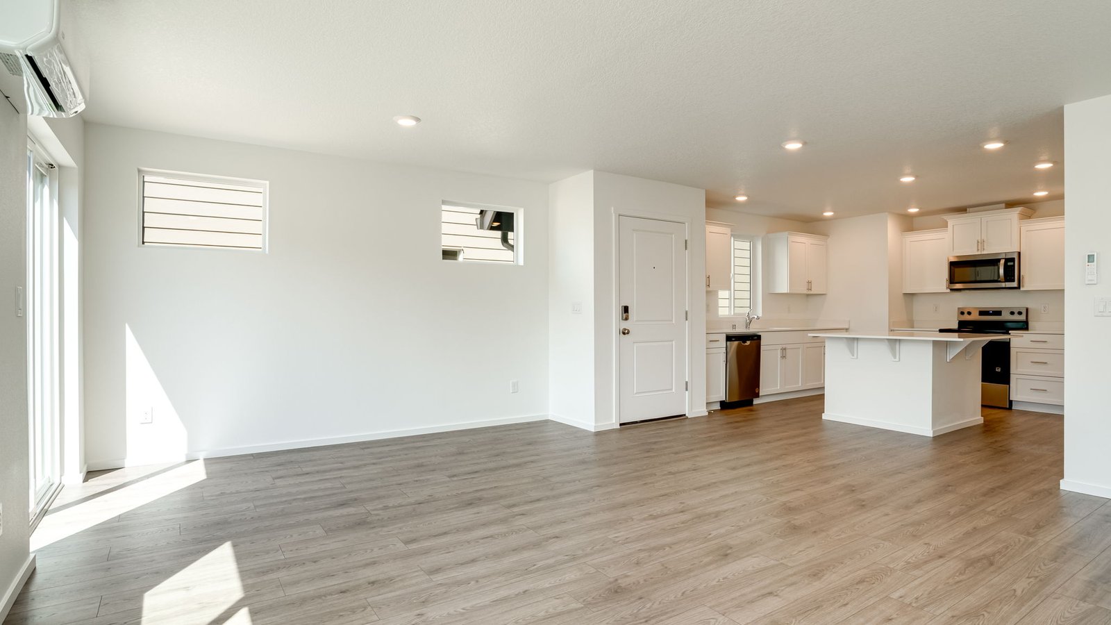 Great room with laminate flooring and an electric fireplace