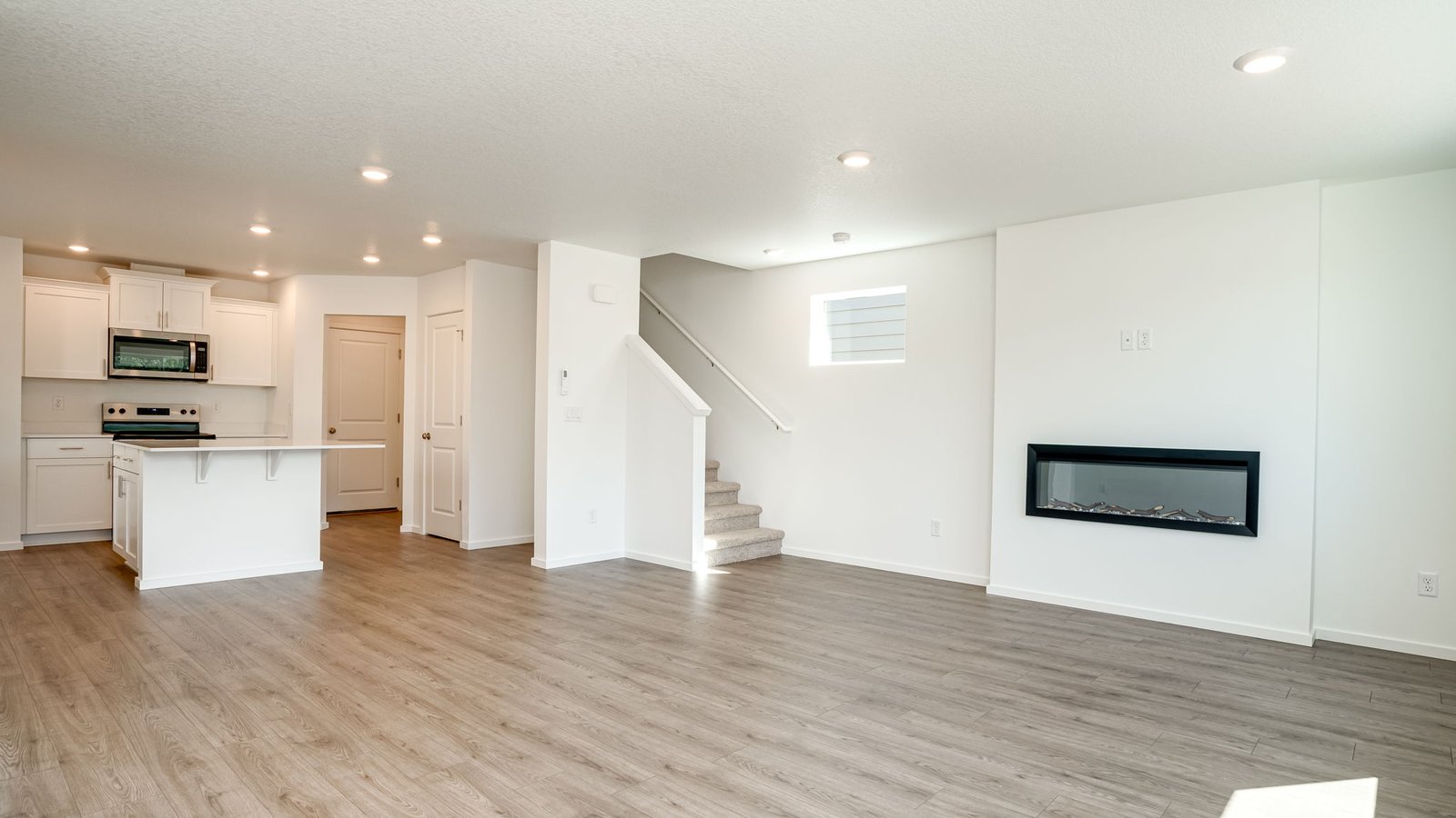 Great room with laminate flooring and an electric fireplace