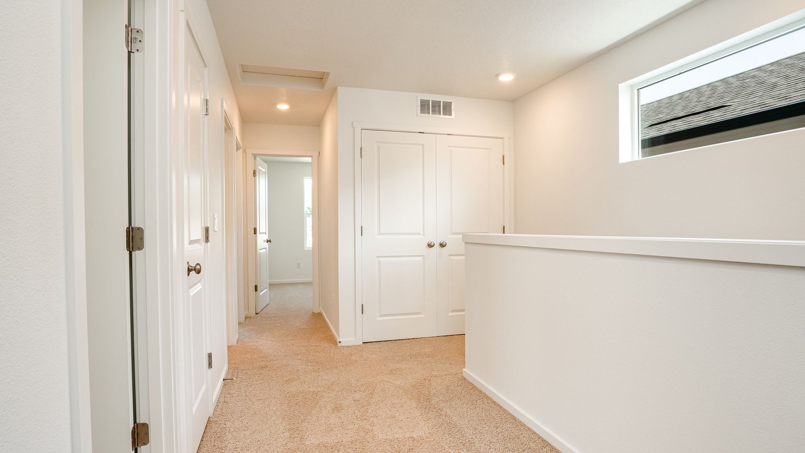 Hallway with wall-to-wall carpet