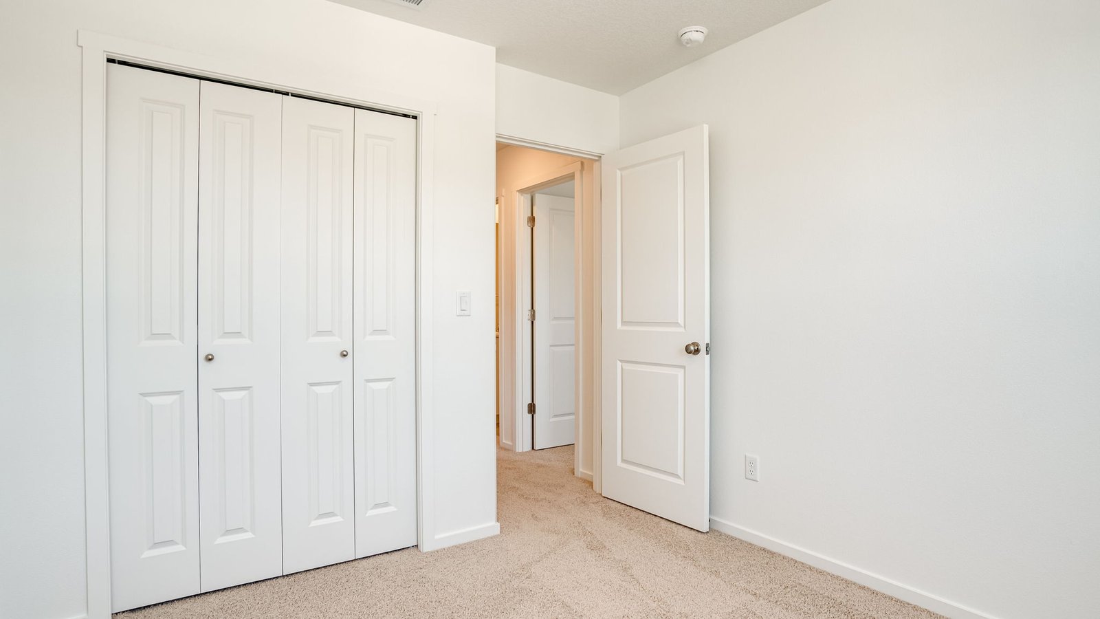 Bedroom with wall-to-wall carpet and a closet