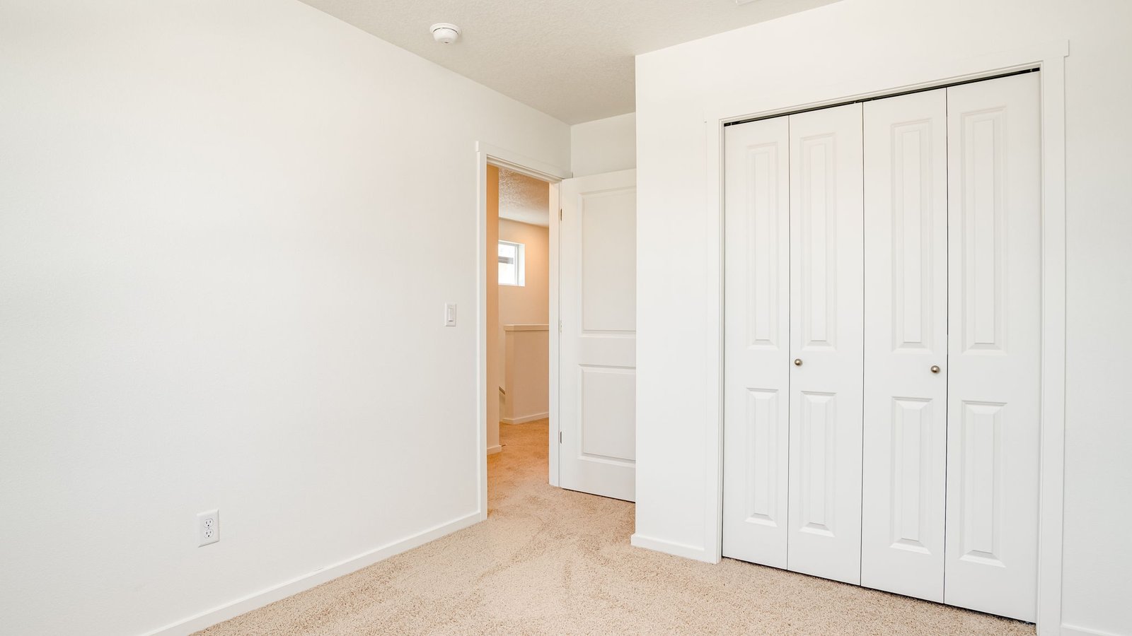 Bedroom with wall-to-wall carpet and a closet